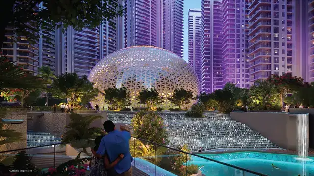 Illuminated clubhouse dome and cascading water features at Elan The Emperor by night
