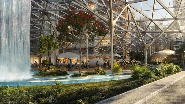 Glass-roofed atrium with waterfall and gardens at Elan The Presidential